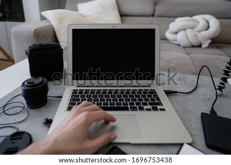 Image of well edited man hands taking photos on his phone. Photo editing. Photographer's home office space. Working remotely - work from home concept.