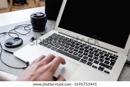Image of well edited man hands taking photos on his phone. Photo editing. Photographer's home office space. Working remotely - work from home concept.