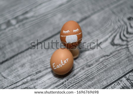 Easter eggs and Coronavirus covid-19. Two brown chicken eggs on the wooden background. Concept on Easter 2020.