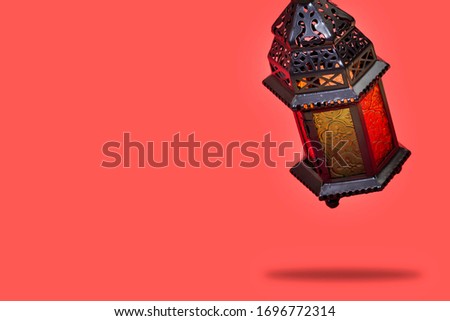 Ramadan Kareem and eid al fitr flying Lanterns Egyptian Fanoos. Lanterns/Arabic lamp fanoos for Ramadan Kareem /Eid al Fitr Mubarak, Translated: Happy & Holy Ramadan Royalty-Free Stock Photo #1696772314