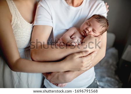 Newborn baby with mom and dad at home

