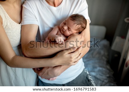 Newborn baby with mom and dad at home
 Royalty-Free Stock Photo #1696791583