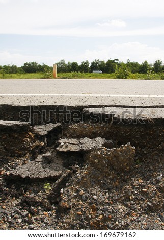 cracked asphalt road after flood ,damaged roadway 