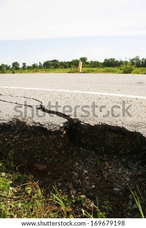 cracked asphalt road after flood ,damaged roadway 