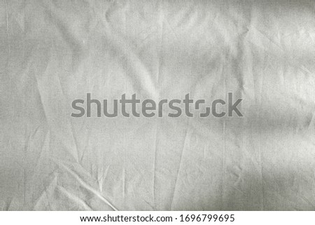 Tablecloth on a wooden table in the light of the morning sun with free space for an advertising product