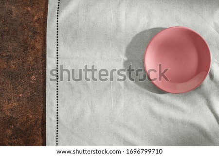 Tablecloth on a wooden table in the light of the morning sun with free space for an advertising product