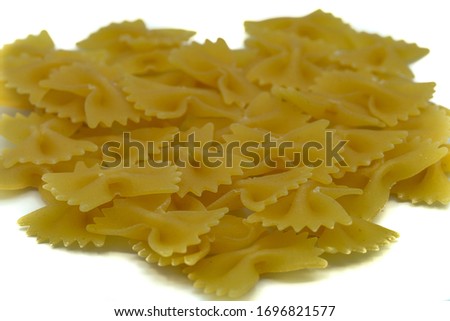 A close up of uncooked Farfalle Pasta isolated on a white background