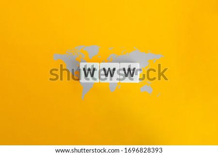 WWW (World Wide Web) on block letters. Grey world map on bright orange background. Minimal aesthetics. Royalty-Free Stock Photo #1696828393