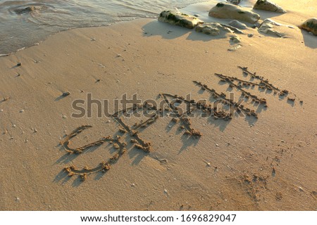 Spain Beach Summer Holiday Hand Written on Sand with Sea or Ocean Water at Sunset. Travel Tourism Vacation Seascape Islands Spanish Resorts Banner Background Image. Royalty-Free Stock Photo #1696829047