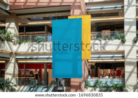 Two empty clean banners hanged inside the shopping mall. Copy space for promo text or logo promotion