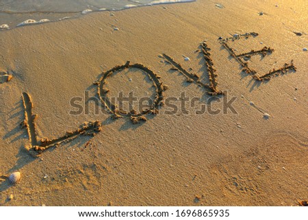 Love Beach Summer Holiday Hand Written on Sand with Sea or Ocean Water at Sunset. Honeymoon Travel Tourism Vacation Seascape Islands Resorts Couple Goals Happiness Banner Background Image. 