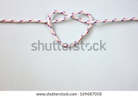Heart Shaped Knot on blue wooden textured background