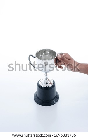 Silver trophy isolated on black background with copy space. Concept winner