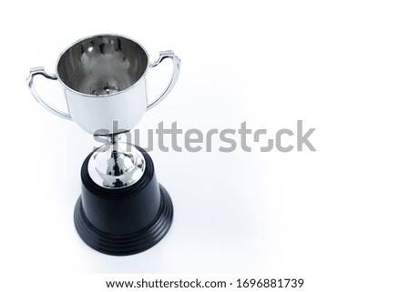 Silver trophy isolated on black background with copy space. Concept winner