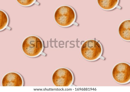 Pattern with white tasty espresso cups on a pink background. Flat lay picture.