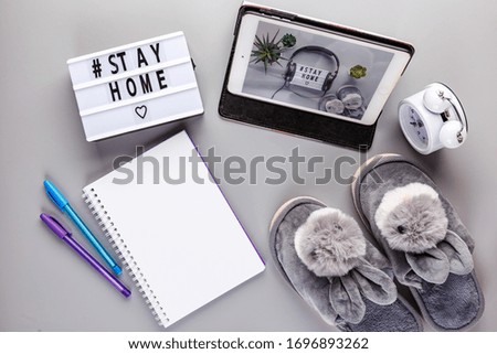 Light box with text STAY HOME on gray background. Healthcare and medical concept. Coronavirus, Quarantine and isolation concept. Covid-19, 2019-nCoV. Top view.