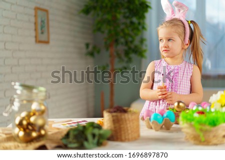 Easter concept. Toddler blonde happy  girl with bunny ears
