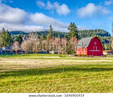 Old red barn on a farm in Oregon. Royalty-Free Stock Photo #1696905919