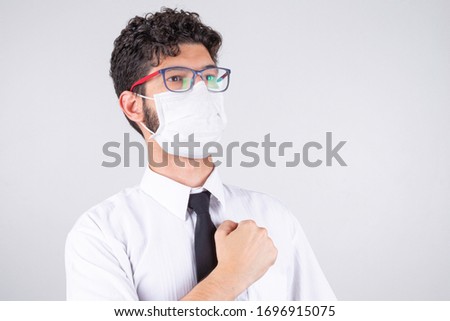 Businessman with closed hand over his heart showing strength to face pandemic.