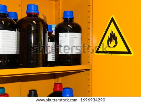 Flammable Chemicals in Protection Cabinet Royalty-Free Stock Photo #1696934290