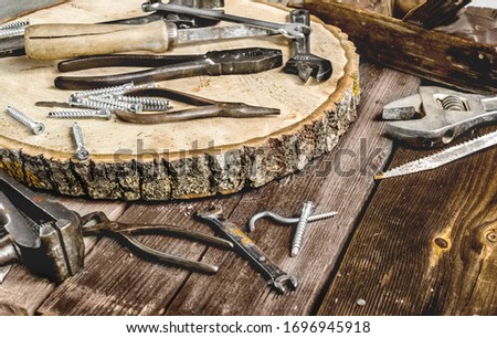 A set of metal tools in the workshop on an old rustic wooden background.concept.Father's day or labor day holiday.A greeting card or banner for your store or website.worker's day