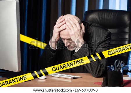 Businessman upset about quarantine closure. Adult man holds his head. Concept - an investor loses money due to quarantines. Man in the office is sad about the virus. Lost his job due to quarantine.