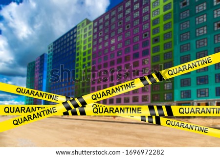 Residential building is quarantined. Concept - house closure due to epidemiological danger. Passage is closed due to the risk of infection. Entrance to the building is closed. Warning yellow tape.
