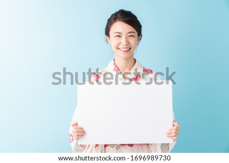 attractive asian woman wearing traditional Japanese casual summer kimono called "Yukata",white board,