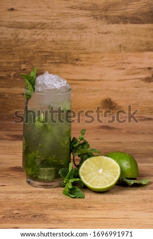 
Glass of mojito with mint and lemon  on wooden background