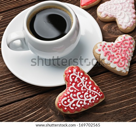 Heart shaped cookies baked on valentines day and a cup of coffee