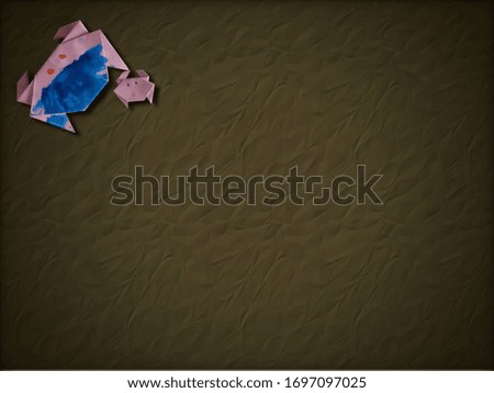 folded paper crabs on wrinkled paper