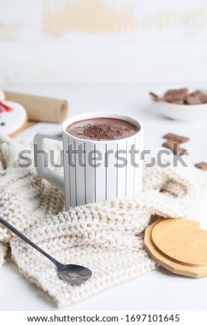 Cup of hot chocolate and cookies on table