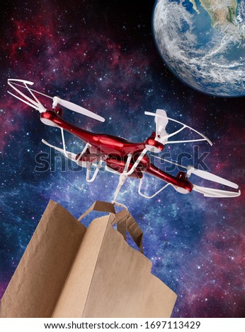 The drone delivers a package with purchases to Earth flying the milky way in space. (Elements of this image furnished by NASA)