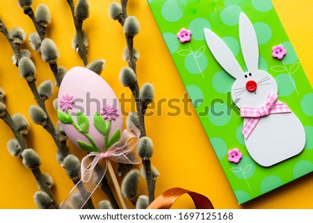 Easter card for children. Easter bunny, colorful eggs and pussy-willow twig