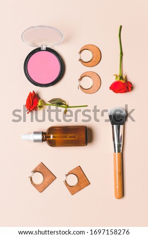 Makeup cosmetics with accessories on light background