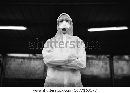 COVID-19 coronavirus doctor in hazmat suit.Infectious disease pandemic medical worker.Female physician in uniform on frontline,fighting viral outbreak.Protective suit with N95 mask. Royalty-Free Stock Photo #1697169577