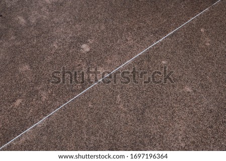white line cross the rough texture floor