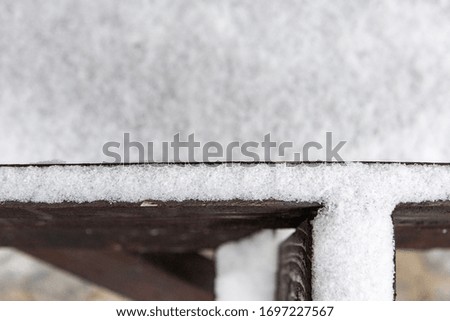 Fresh snow on wooden roof; selective focus image; close-up image