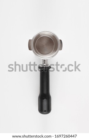Filter holder for espresso coffee machine on white background.