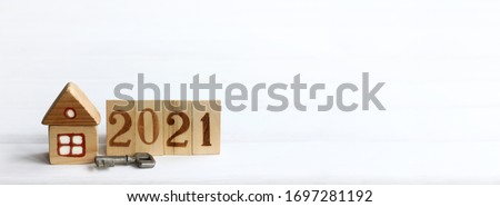 wooden house and a metal key with a fence and painted numbers. eco-friendly individual housing in 2021 Royalty-Free Stock Photo #1697281192