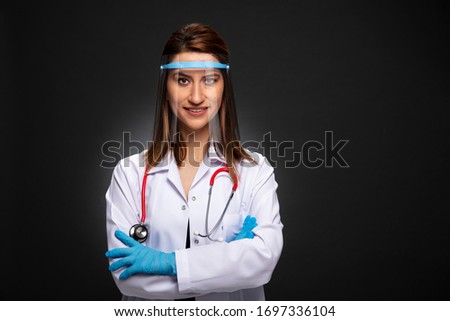 Pandemic doctor posing on black backgroynd.