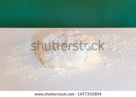 Handmade dough for bread on a white marble background, homemade cooking.