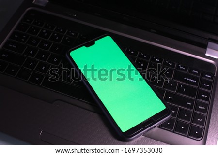 A smartphone with green screen (Chroma key). Open conceptual for technology stuff.

