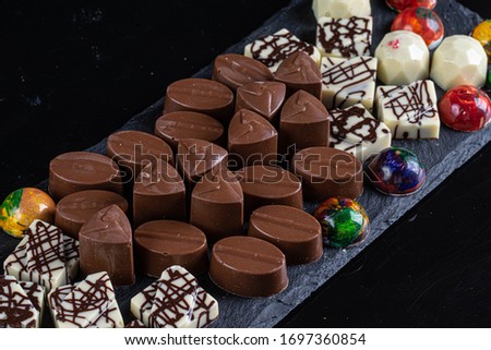 chocolate candies on black stone black background 