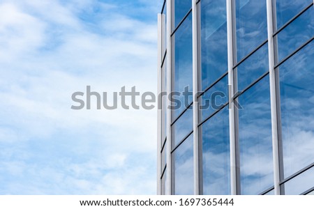 Modern building facade agains blue sky with copy space, modern architecture with glass and aluminium.