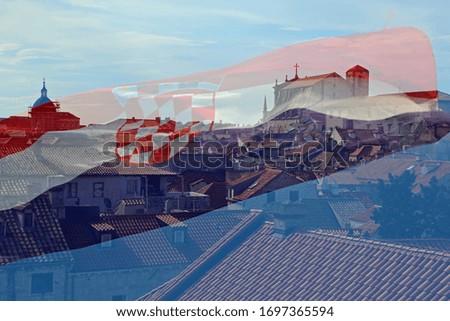 The photo shows a panorama view on Dubrovnik, Croatia in the background and the waving croatian flag in the foreground by double exposure.