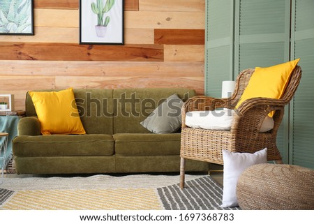 Interior of modern room with comfortable armchair and sofa in room