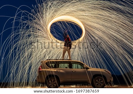 A steel wool on fire at night (night photography using a slow shutter speed) - selective focused on the subject.