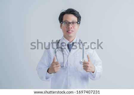 healthcare and medical concept - young male doctor with stethoscope. Asian male model