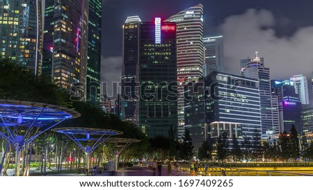 Business Financial Downtown City and Skyscrapers Tower Building at Marina Bay night view from walking area, Singapore, Cityscape Urban Landmark and Business Finance District Center